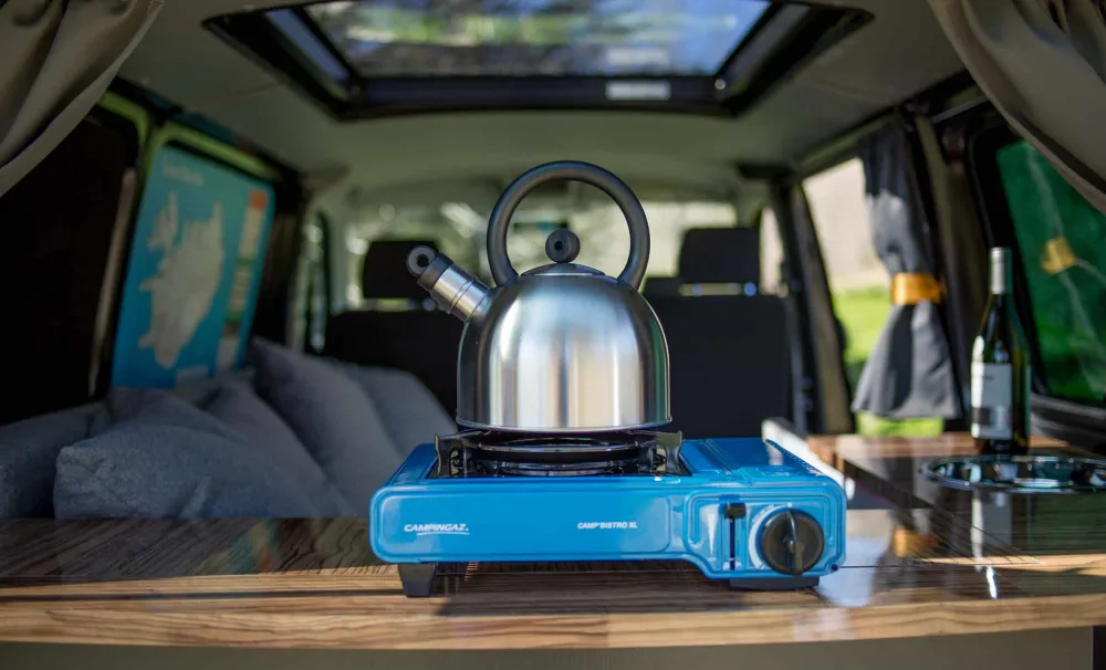 gas stove with tea kettle in camper