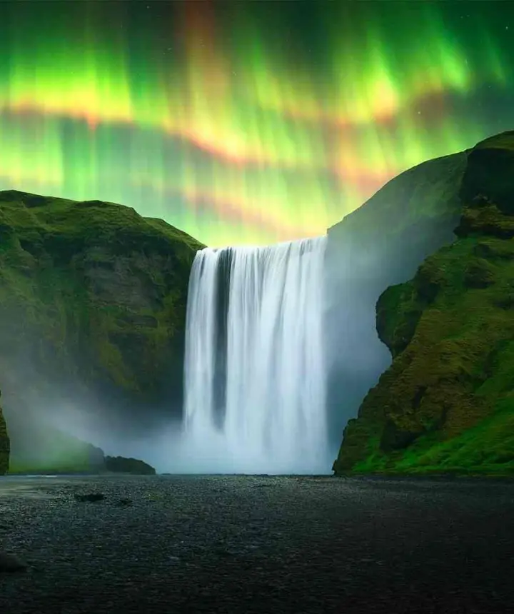 Skógafoss waterfall under the northern lights