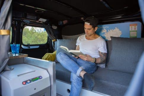 man sitting on couch in camper