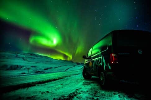 camper under Northern lights sky
