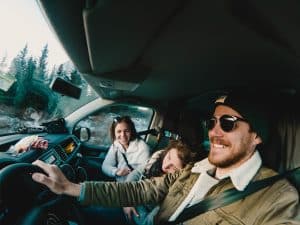 family in cockpit of campervan, renting a camper van